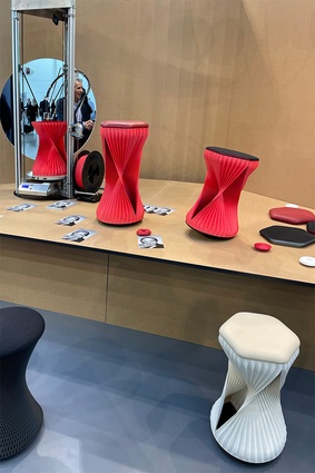 Stools promoting balance are seen here being 3D printed live on-site at Orgatec.