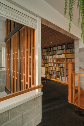 A semi-enclosed library space on the second storey provides an area for quiet contemplation.