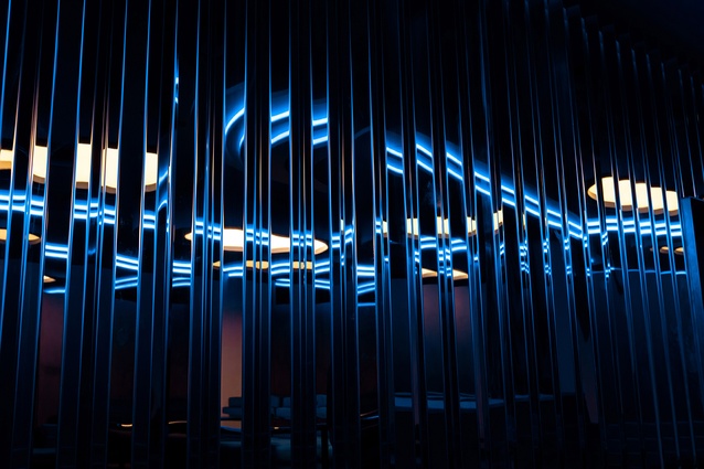 Custom made, stainless steel wall linings under blue light. 