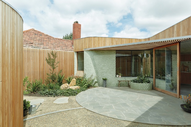 The privacy of the courtyard can be moderated by opening or closing a hinged timber screen.