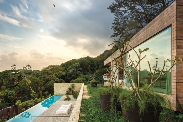 Creepers and large pots of plants help the house integrate into the tropical environs. 