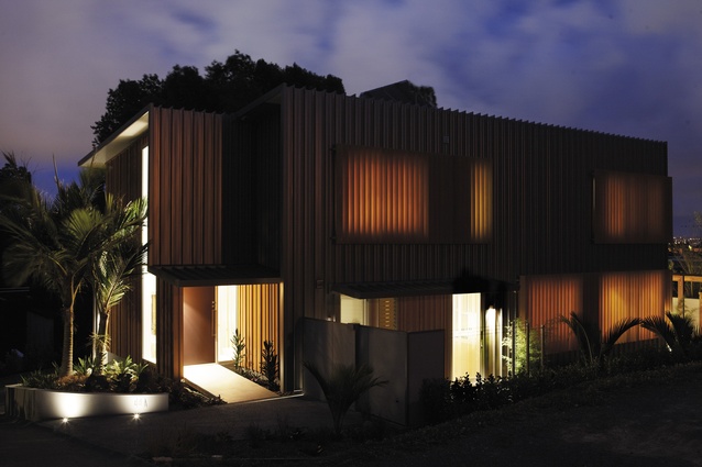 Clever lighting and cedar fins give the home some drama.