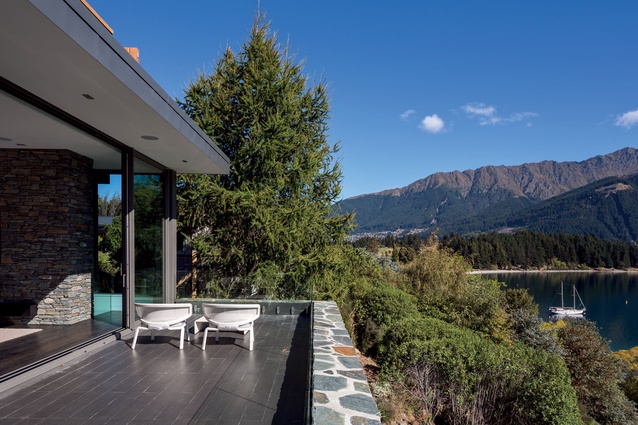 The mix of materials – cedar, schist, glass and stone used inside and out – helps connect the house to the landscape.