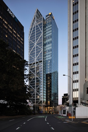 The tower’s western face includes the side core lifts and stairs and the decorative diagrid outside the curtain wall.