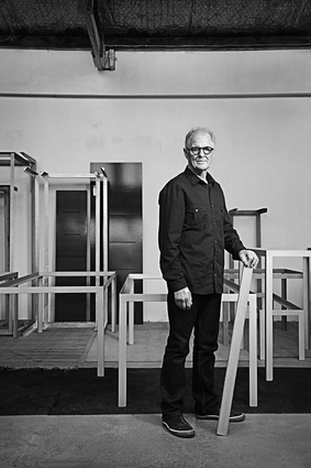Bob McDonald surrounded by steel table frames.