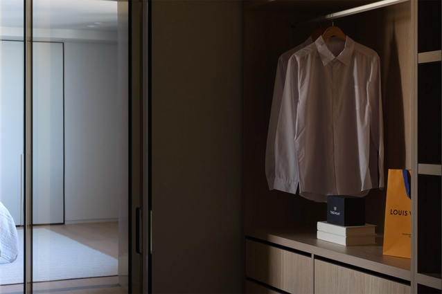 Space-saving and stylish inbuilt wooden veneer cabinetry provide a seamless and easy-assess wardrobe solution. 