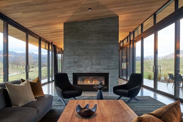 Shuttered concrete carries through to the fireplace surround and is warmed by cedar ceilings.