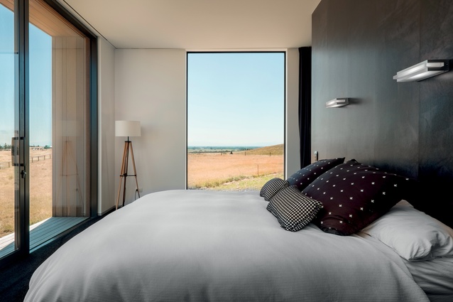 The main bedroom has black walls, carpet and curtains to contain the stunning scenery outside.