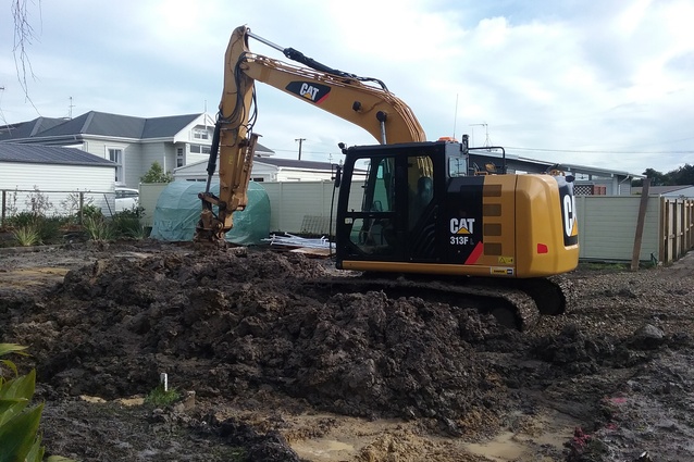 Excavator at work on the basement at the Living House site, Beachlands.