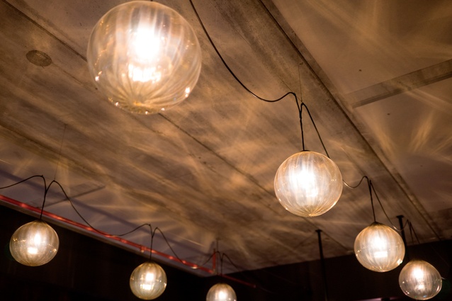 Luke Jacomb created the blown-glass lights, which are strung in a casual fashion over the downstairs space. 