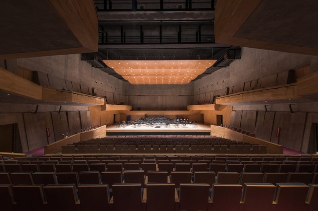 Foro Boca, Mexico by Rojkind Arquitectos. The main 966-seat orchestra hall features simple finishes of exposed concrete walls and wooden balconies that mirror the aesthetic of the building's exterior.