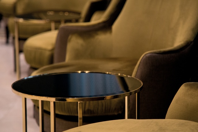 Circular shapes and furniture with a mixture of eras and influences offer a comforting yet luxurious atmosphere to the hotel lobby.