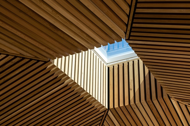 The cedar batten-lined ceiling in the living space was designed to “open and soften the living area, creating a larger atmosphere out of what is essentially an intimate area”.