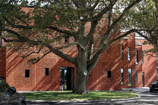 Playfully undulating openings are set in the perforated brick façade, which is conceived as a ‘speaker box’ to emit sound from practice rooms through glazed sliding doors.