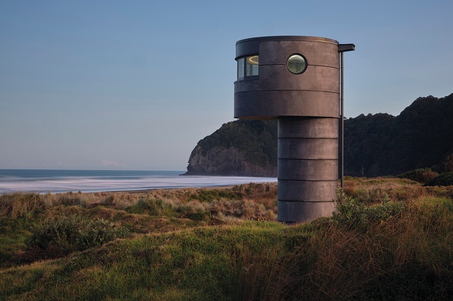 The tower's black oxide concrete exterior references the black sands of the west coast beach where is stands in North Piha.