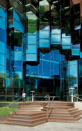 The GLHC façade and stairs. At the entrance, the geometry of the smooth sphere is eroded at the glass walls in order for the building to address the street openly.