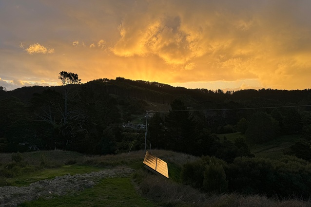 The ground-mounted solar panels installed on site at Lower Saddle Passive House, overlooking the settlement of Tahekeroa.