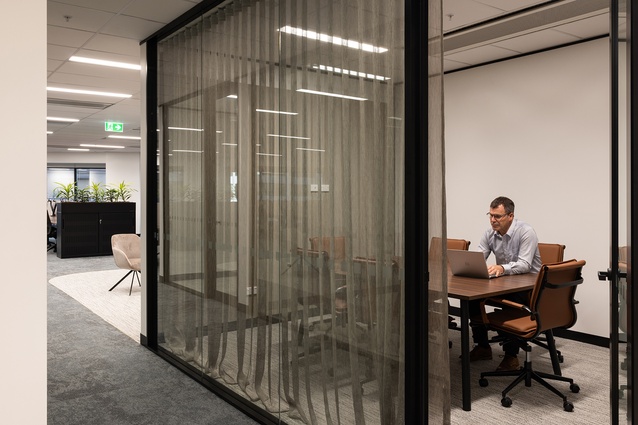 The subtle sheen of Cyprus drapery in the meeting rooms complements the bronze accents throughout the project.