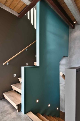 The staircase has a splash of teal against the natural colour palette. 
