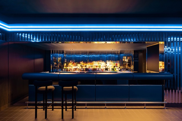 The bar, where the RGB lighting system, rich materials and bar content cohesively mix to create the unique mood of Quinn Bar. 