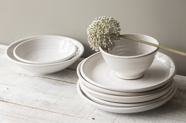 The modern, urban table range is created with a milky white glaze on burnt orange stoneware.