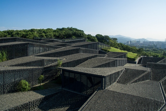 China Academy of Arts by Kengo Kuma. These folk-art galleries are designed to look like a small village, with thousands of curved tiles covering the gabled rooftops.