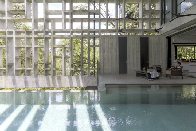 The living room and swimming pool of the Tropical Box House are encased in a metre-deep lattice of concrete.