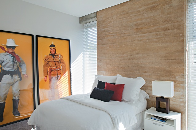 In one of the bedrooms, massive walls are contrasted with full-height windows. 