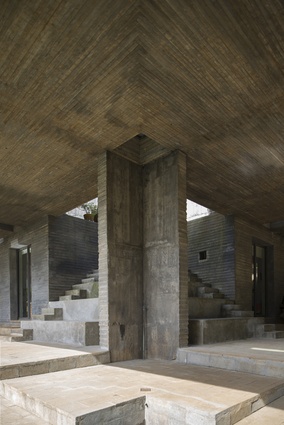 The rough texture of the concrete interior manages to appear warm and forgiving.