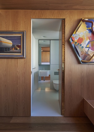 The extensive use of timber throughout the apartment is offset by coloured bathrooms.