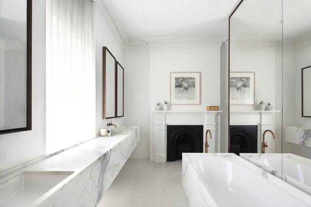 Honed marble, waxed brass taps and mirror surrounds acknowledge the historic significance of the home. 