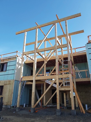 CLT floors and ceilings were used and internal framing was made with LVL posts and beams along with exterior glulam posts and beams for the breezeway access and prefabricated deck units.