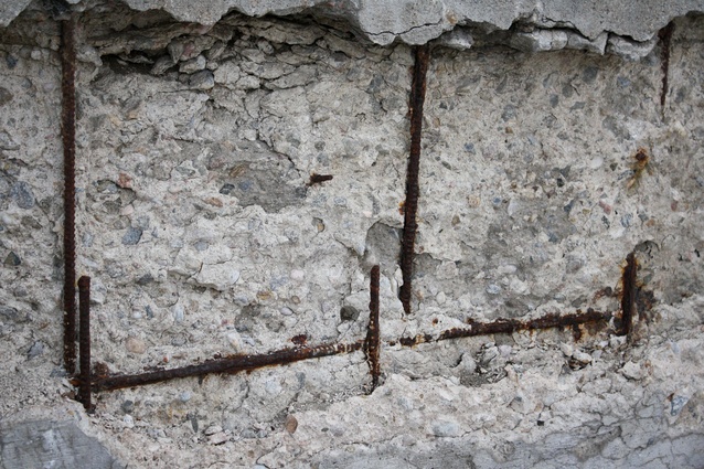A concrete wall showing advanced stages of rust packing.