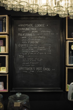 The blackboard is framed in an old picture frame. The milk-bottle pendant was designed by the architecture firm and is suspended from the beam indicated in the plan.