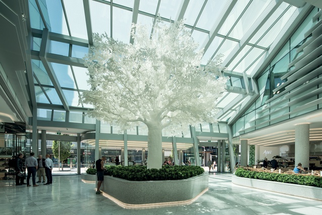 The atrium features a white, artificial tree, a memorable point of reference for the building. 
