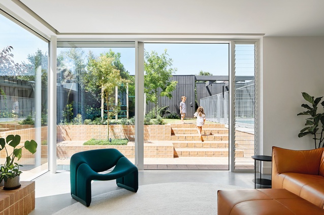 A series of brick plinths and stairs traverse the backyard’s steeply rising landscape.