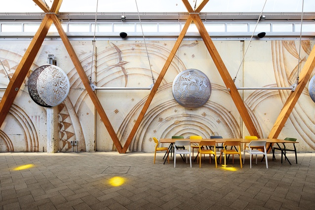 The Michel Tuffery artwork and timber legs march down the arcade.
