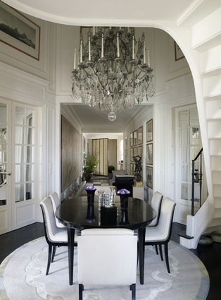 One of Takada’s favourite pieces in the apartment – a Mathieu Lustrerie chandelier – adorns the monochrome dining room. 