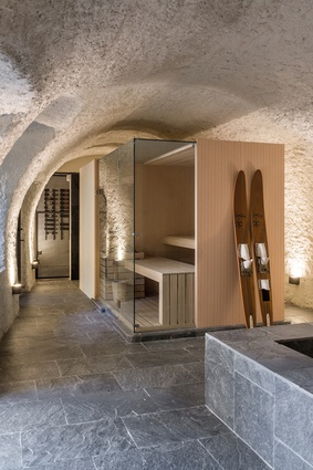 A sauna is located in this cavern-like bathroom.
