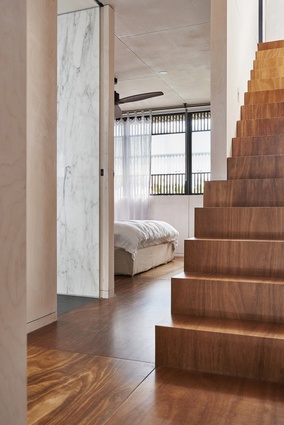 The bedrooms are pragmatically planned and finished in plywood panelling, while crafted stairs lead to the roof.

