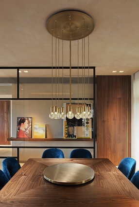 Lee Broom pendants hang above the bespoke dining table surrounded by Flexform Mood Judit dining chairs. 

