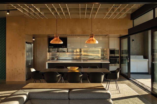 A lowered plywood ceiling articulates the kitchen space and incorporates acoustic baffling.