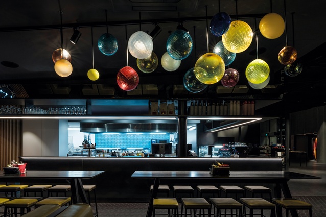 Highlights include glass orbs by artist Luke Jacomb and neon accents.