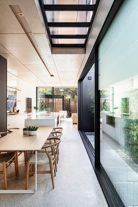 A glazed upper floor, large doors and a mirrored splashback make modest proportions appear expansive.