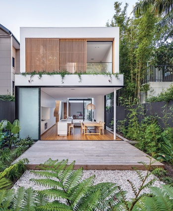 Minimalist glass doors and operable timber screens open the interior spaces to the garden