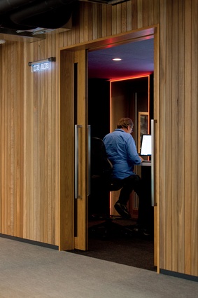 The retro-look timber panelling brings an element of warmth and texture to the fast-paced, hi-tech environment. 