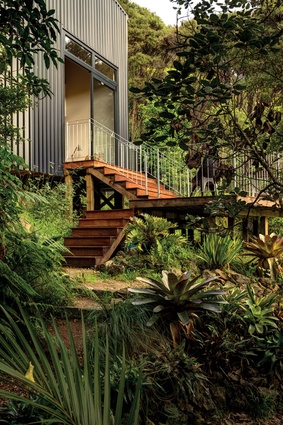 Steps from the lounge flow to a second outdoor area and bush access.