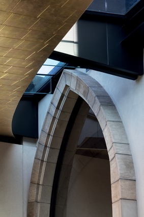 Overhead, an elliptical wedge of glazing draws in light to the back of the chapel.
