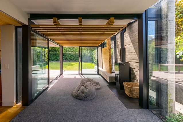 The largely timber and concrete garden room features a floating timber structure, which is a continuation of the exterior pergola.