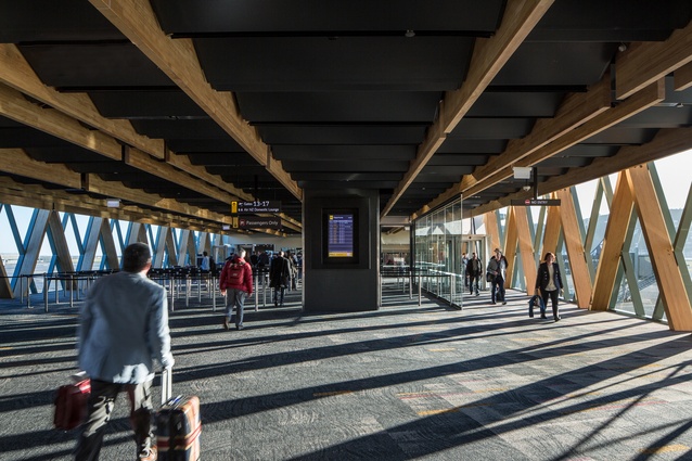 The Wellington Airport South West Pier link extension features a folded perforated metal ceiling panel system and timber façade structure that provides a sense of warmth.